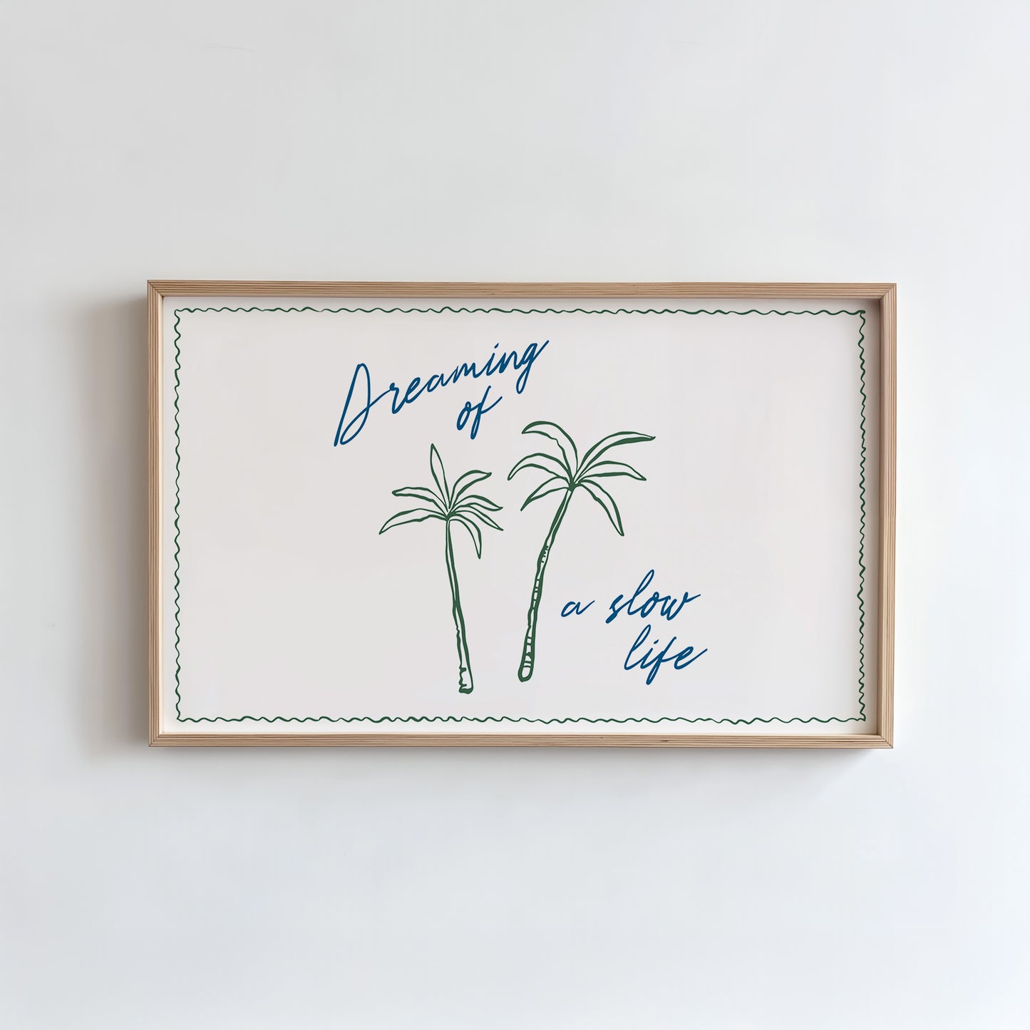 Framed artwork with palm trees and text on a white wall