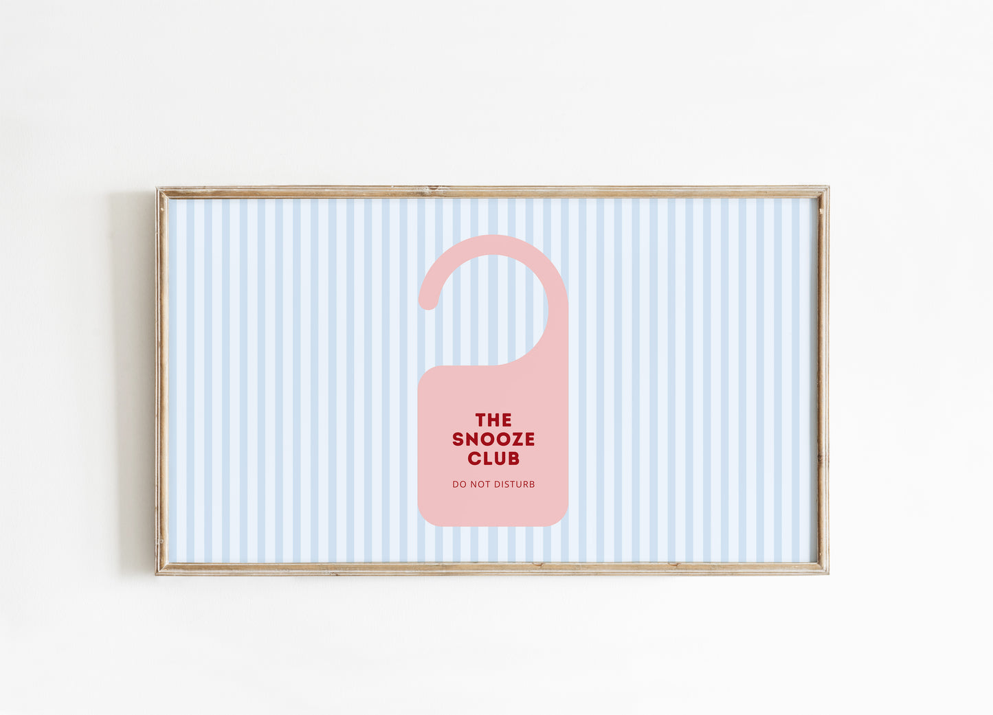 Framed artwork with a pink door hanger and text on a striped background