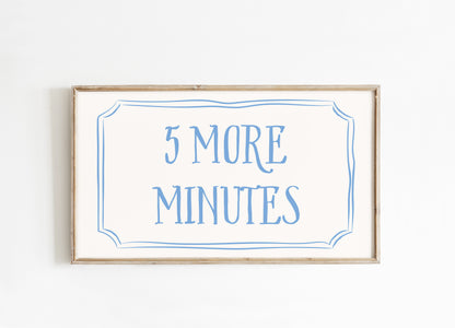 Framed sign with '5 More Minutes' text on a white background