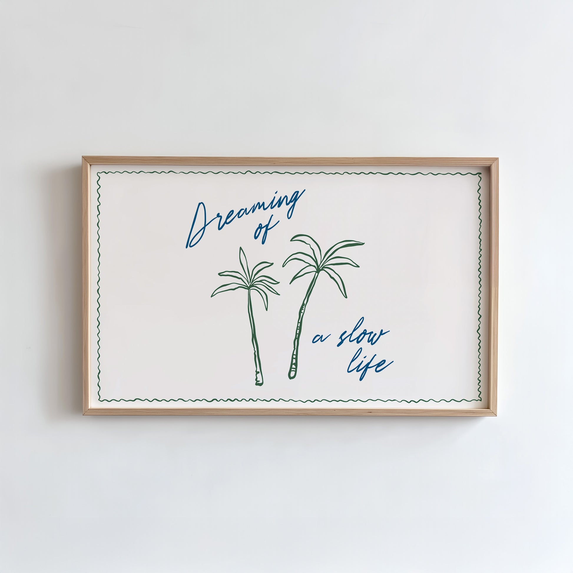 Framed artwork with palm trees and text on a white wall