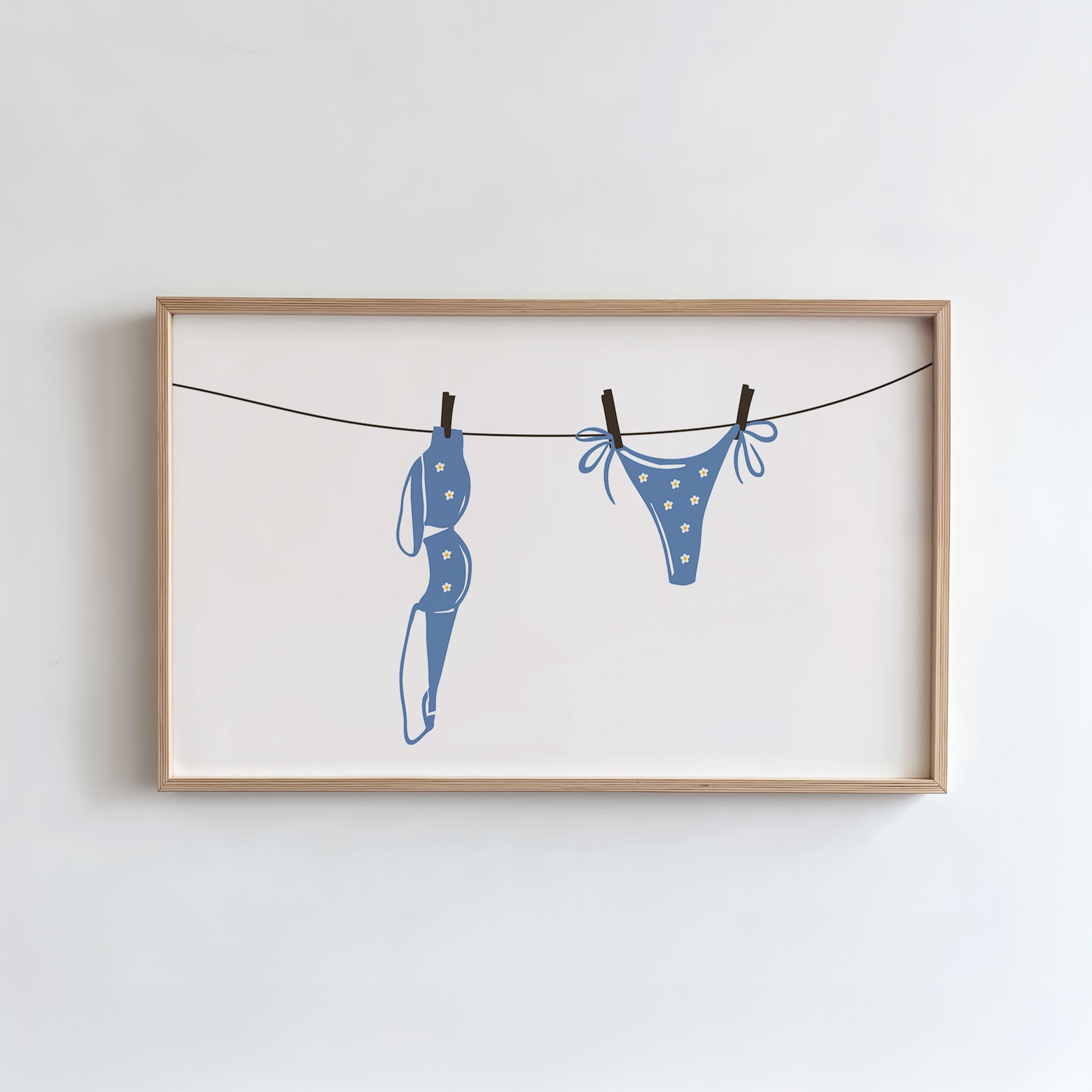 Framed artwork of blue underwear on a clothesline against a white background