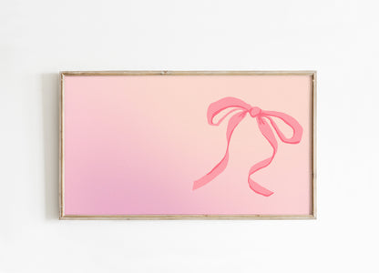 Framed artwork with a pink bow on a gradient background