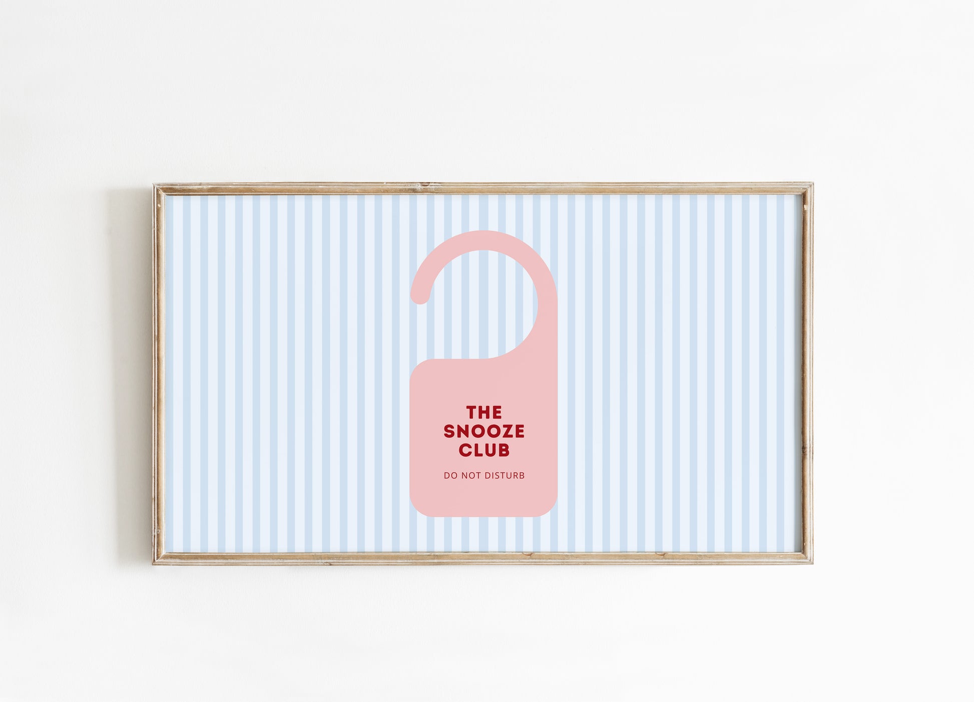 Framed artwork with a pink door hanger and text on a striped background