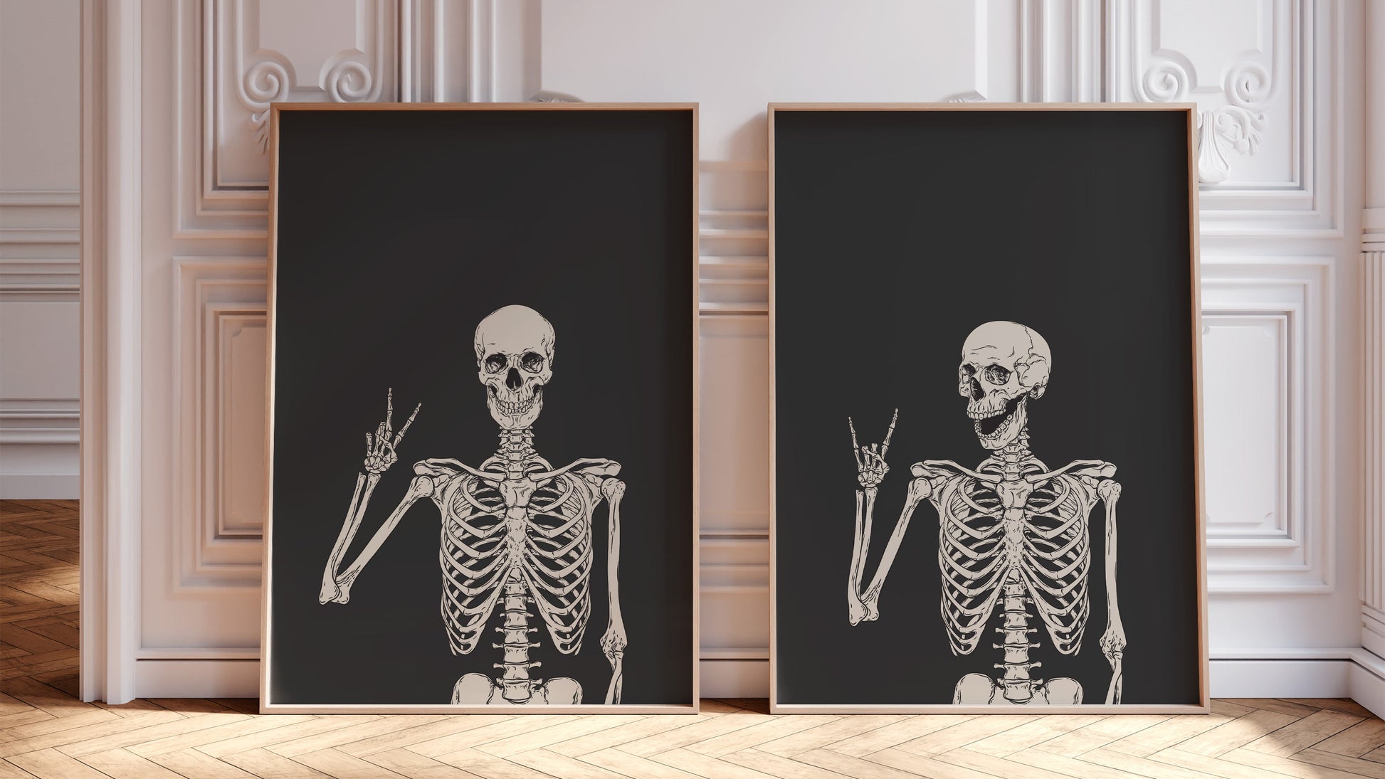 Two framed skeleton prints on a wall with decorative molding.