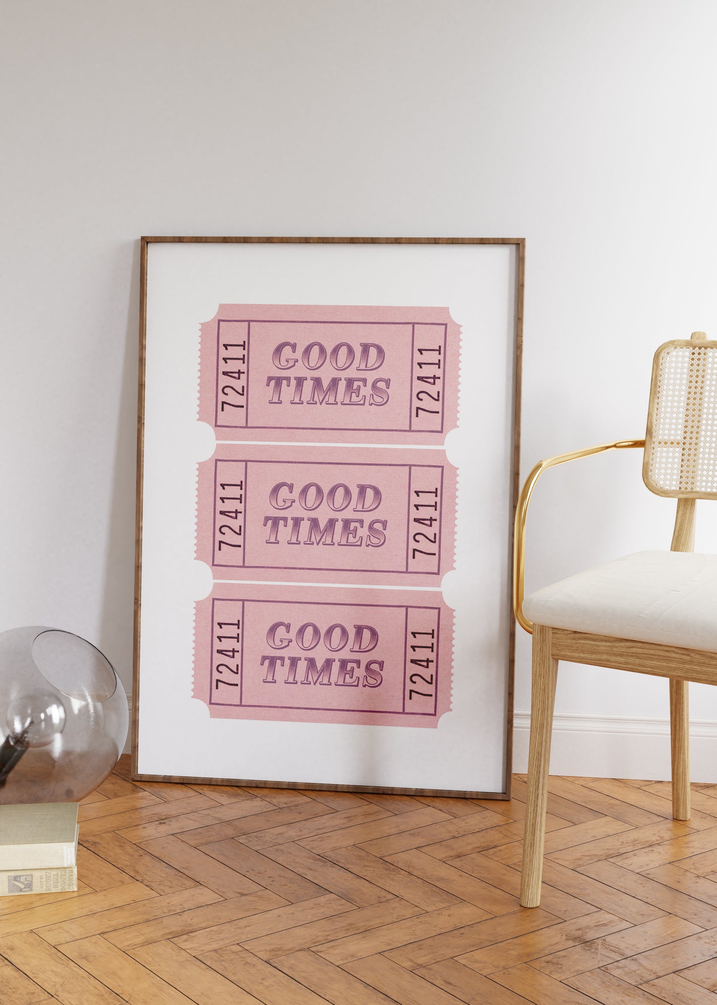 Framed print with 'Good Times' tickets in a room with a chair and decor items.